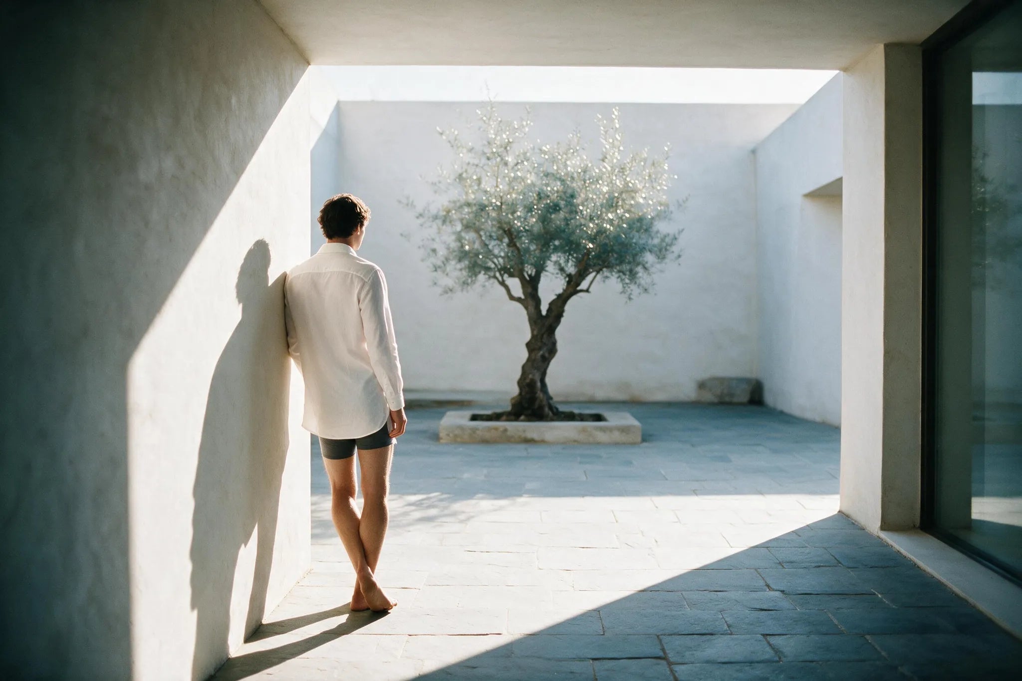 A man wearing ātem in everyday life, warm natural light